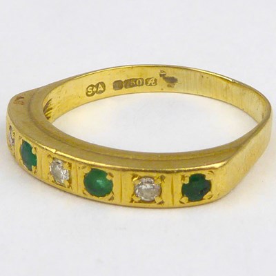 Lot 842 - An 18ct gold diamond and emerald half eternity...