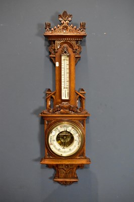 Lot 1572 - A 19th century carved oak aneroid barometer.