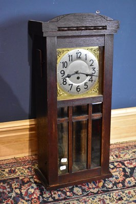 Lot 2333 - A 1920's oak wall clock with silvered dial, 79cm.