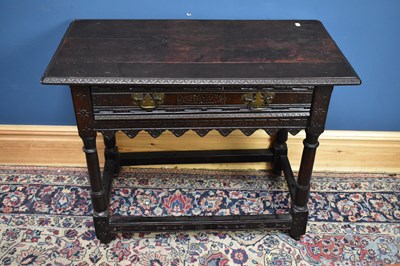 Lot 2436 - An 18th century oak side table, with carved...