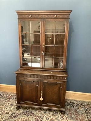 Lot 2479 - A 1920s oak bookcase, with carved and moulded...