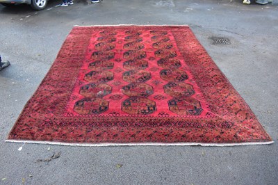 Lot 2283 - A large Eastern style red ground rug with...