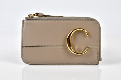 Lot 948 - CHLOE; an unused beige leather coin purse and...