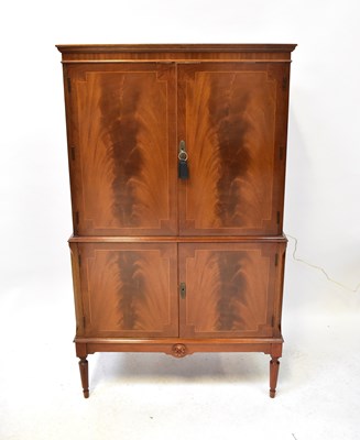 Lot 30 - A Regency-style mahogany drinks cabinet, the...