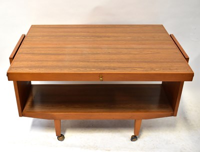 Lot 27 - A mid-20th century metamorphic sideboard/table,...