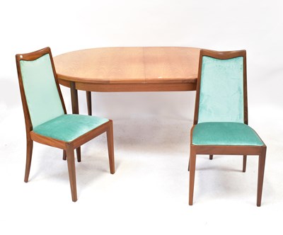 Lot 19 - G-PLAN; a teak extending dining table with one...