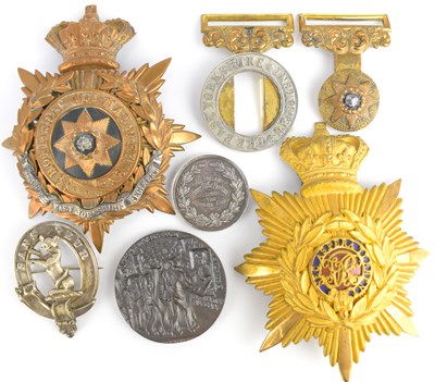 Lot 480 - THE EAST YORKSHIRE REGIMENT; two helmet badges,...