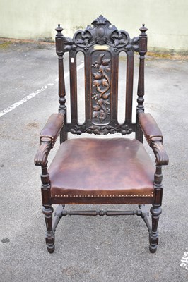 Lot 2534 - An early 20th century carved oak elbow chair,...
