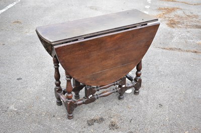Lot 2380 - An 18th century oak drop leaf gateleg dining...