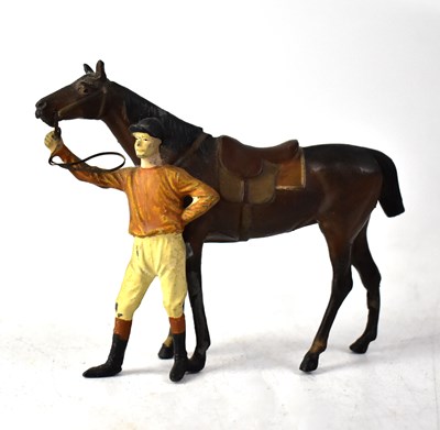 Lot 135 - A painted metal model of a horse being held by its rider