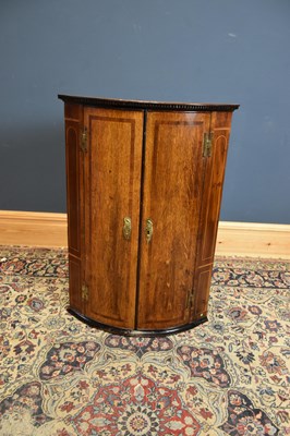 Lot 6540 - A Georgian oak bowfront hanging corner...