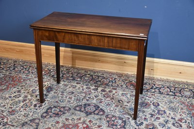 Lot 6631 - A Georgian mahogany fold over tea table on...