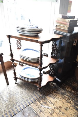 Lot 1204 - A Victorian walnut three tier whatnot with...