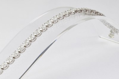 Lot 904 - An 18ct white gold diamond set tennis bracelet,...