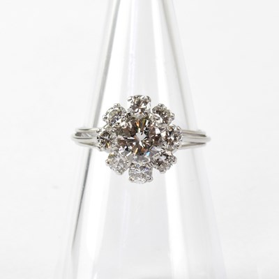 Lot 805 - A white metal ring set with nine diamonds in a...
