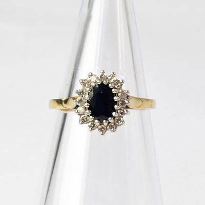 Lot 885 - A 9ct gold diamond and sapphire cluster ring,...