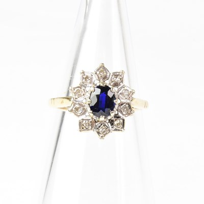 Lot 886 - A 9ct gold diamond and sapphire cluster ring,...