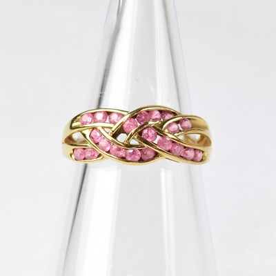 Lot 881 - A 9ct gold ring set with pink sapphires in a...
