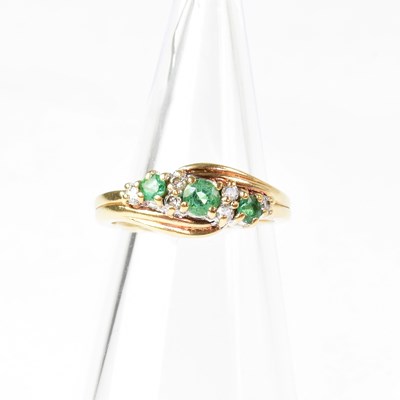 Lot 887 - A 9ct gold ring set with three emeralds...