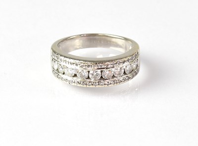 Lot 825 - An 18ct white gold diamond set half eternity...
