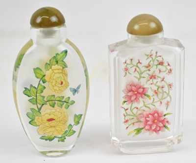 Lot 660 - Two Chinese glass snuff bottles with stoppers,...