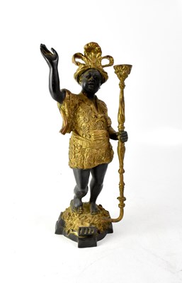 Lot 448 - An early 20th century bronzed and gold painted African figure