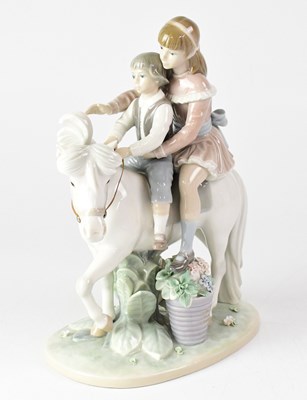 Lot 338 - LLADRÓ; a figure group 'Pony Ride', depicting...