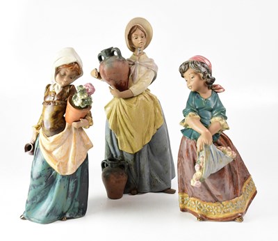 Lot 344 - LLADRÓ; three matte finish figures of girls,...