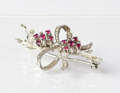 Lot 921 - An 18ct white gold diamond and ruby set brooch...