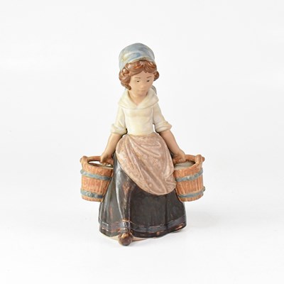 Lot 326 - LLADRÓ; a figure of a young lady carrying two...