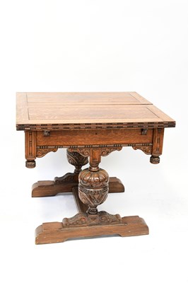 Lot 43 - An early 20th century oak fold-over draw-leaf...