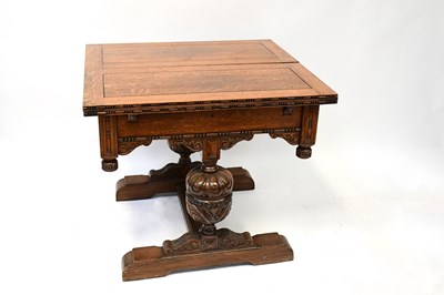 Lot 43 - An early 20th century oak fold-over draw-leaf...