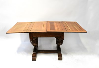 Lot 43 - An early 20th century oak fold-over draw-leaf...