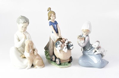 Lot 321 - LLADRÓ; three figures of children with animals,...