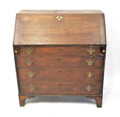 Lot 33 - A George III oak bureau with four long...