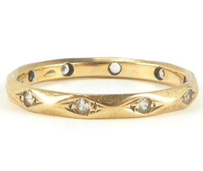Lot 871 - A 9ct gold eternity band ring set with ten...