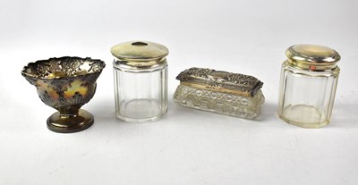 Lot 671 - Three glass dressing table jars with...