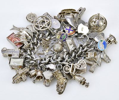 Lot 2318 - A substantial silver charm bracelet set with...