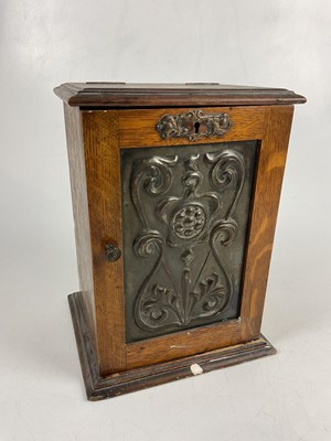 Lot 5064 - A small oak smoker's cabinet with embossed...