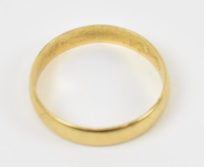 Lot 793 - An 18ct yellow gold wedding band, size Q/R,...