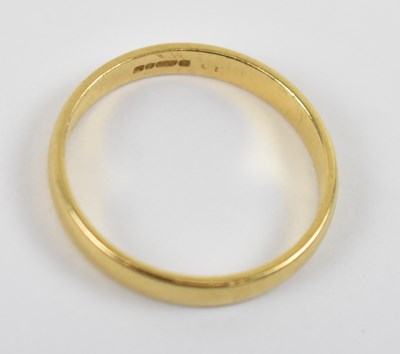 Lot 801 - An 18ct yellow gold wedding band, size K/L,...