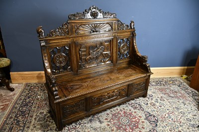 Lot 6505 - A large late Victorian carved oak settle...