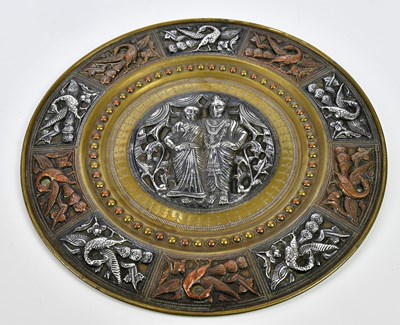 Lot 1194 - An Eastern mixed metal plate decorated with a...