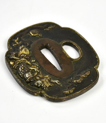 Lot 1185 - A Japanese bronze tsuba with gilt highlights,...