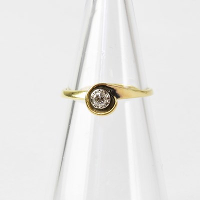 Lot 836 - An 18ct gold diamond solitaire ring in a white...