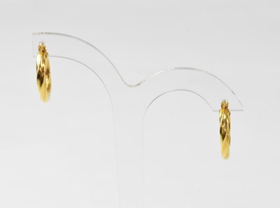 Lot 965 - A pair of 18ct yellow gold hoop earrings,...