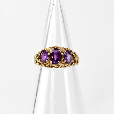 Lot 874 - A 9ct gold ring set with three graduated...