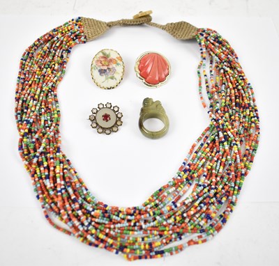 Lot 809 - An Eastern bead necklace, a green hardstone...