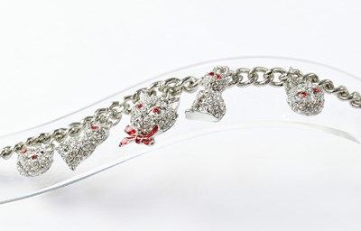 Lot 1008 - BUTLER & WILSON; a charm bracelet with crystal...
