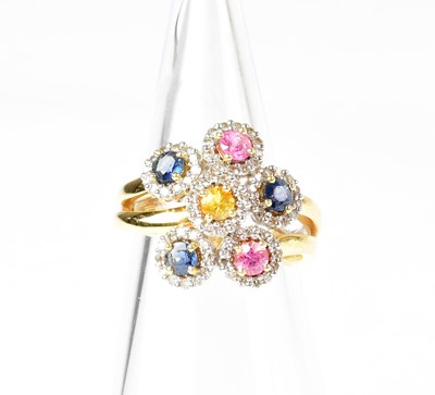 Lot 900 - A yellow metal ring set with pink, blue and...